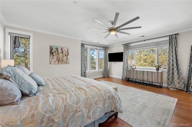 bedroom with ornamental molding and wood-type flooring