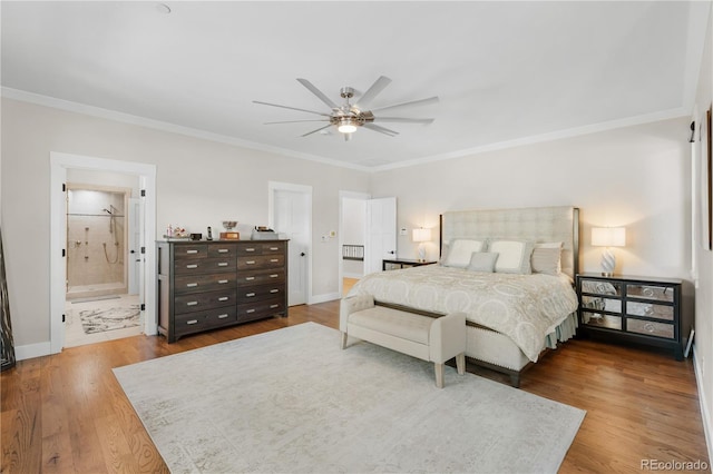 bedroom featuring hardwood / wood-style floors, ornamental molding, ceiling fan, and ensuite bathroom