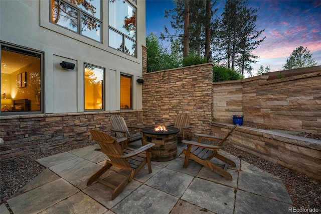 patio terrace at dusk with a fire pit