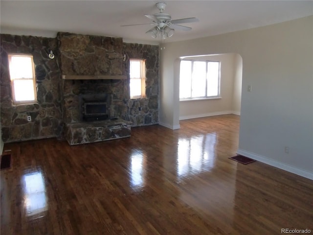 unfurnished living room featuring hardwood / wood-style floors, a wealth of natural light, and ceiling fan