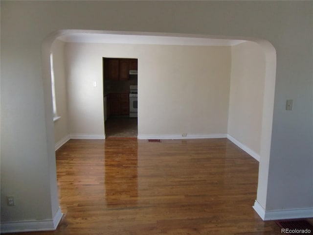 spare room with dark hardwood / wood-style floors