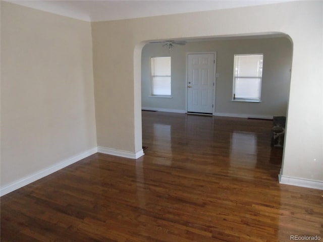 entryway featuring a wealth of natural light, dark wood-type flooring, and ceiling fan