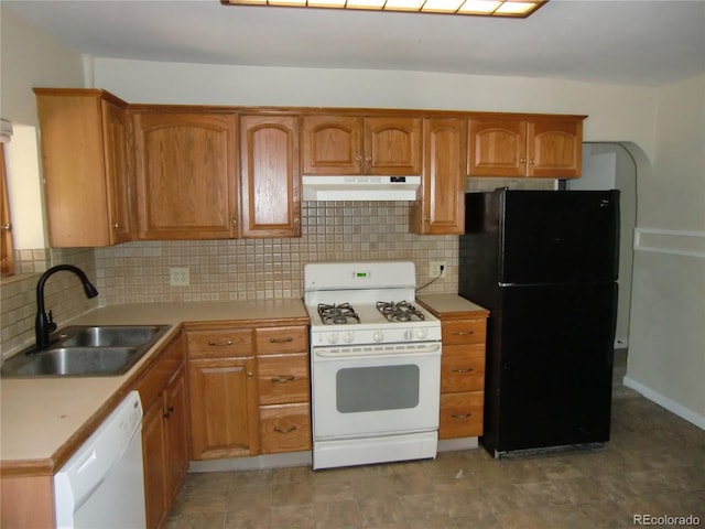 kitchen with tasteful backsplash, sink, and white appliances