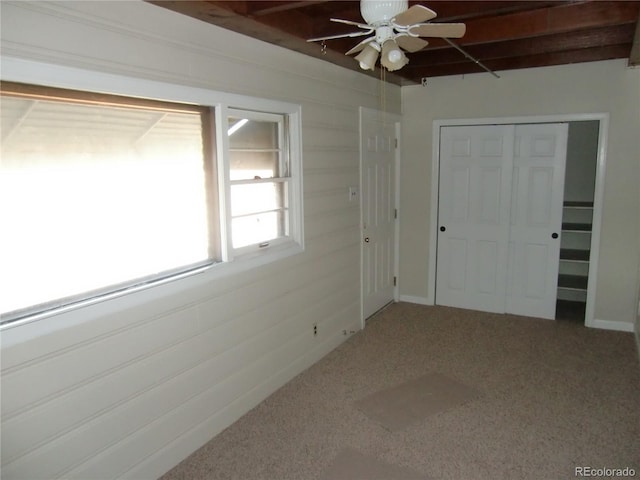 unfurnished bedroom with carpet flooring, ceiling fan, and a closet