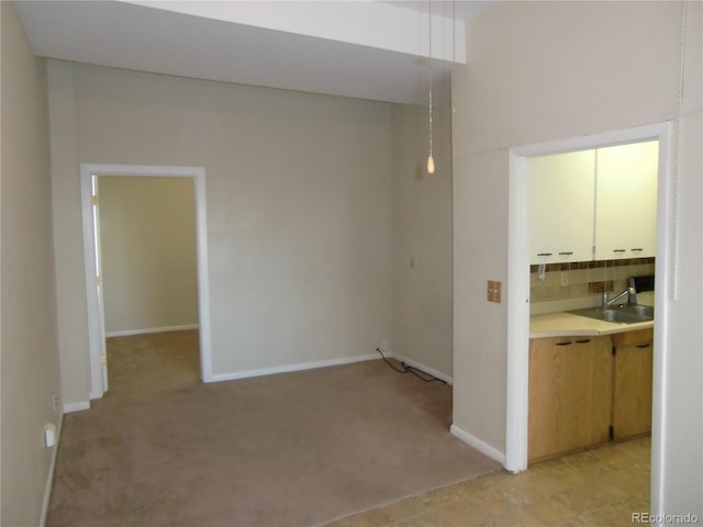 interior space with light colored carpet and sink