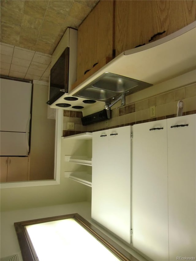 interior details featuring white cabinets