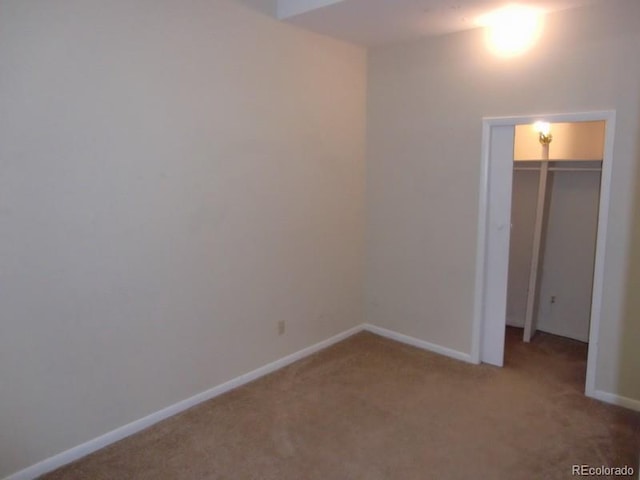 unfurnished bedroom with a closet and carpet flooring