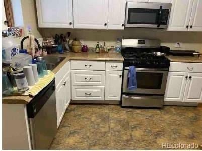 kitchen with white cabinetry and stainless steel appliances