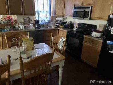 kitchen with tile counters, sink, and black appliances