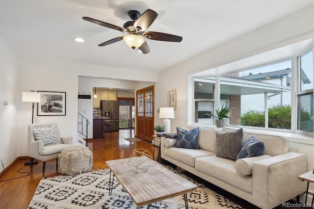living area with recessed lighting, baseboards, a ceiling fan, and dark wood-style floors