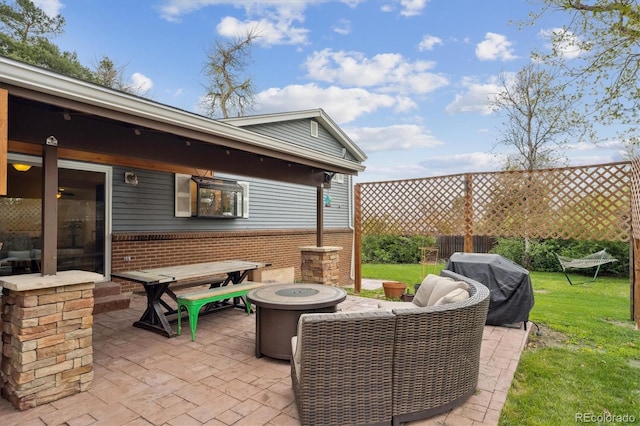 view of patio featuring a fire pit and a grill