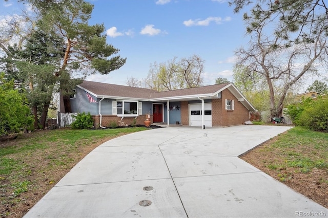 ranch-style home featuring brick siding, a garage, a porch, a front yard, and driveway