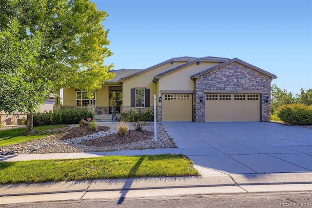16626 Las Brisas Dr, Broomfield, CO 80023 - view of front of home with a garage, stone siding, concrete driveway, and stucco siding