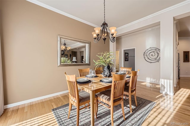 16626 Las Brisas Dr, Broomfield, CO 80023 - dining room featuring a chandelier, crown molding, and wood finished floors