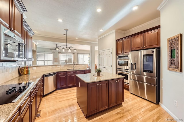 16626 Las Brisas Dr, Broomfield, CO 80023 - kitchen with appliances with stainless steel finishes, crown molding, decorative backsplash, a peninsula, and light wood-style flooring