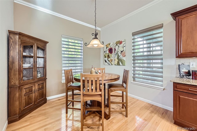 16626 Las Brisas Dr, Broomfield, CO 80023 - dining area featuring light wood finished floors and crown molding