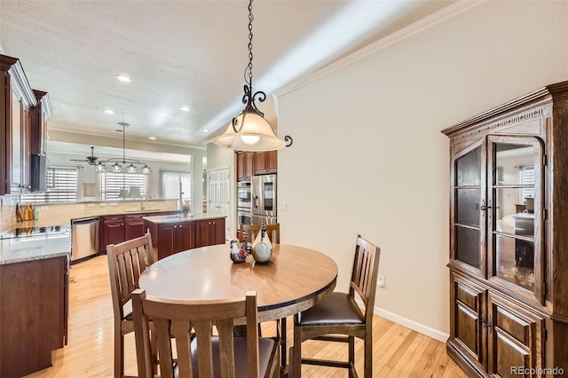 16626 Las Brisas Dr, Broomfield, CO 80023 - dining area featuring light wood finished floors, ornamental molding, a ceiling fan, and recessed lighting
