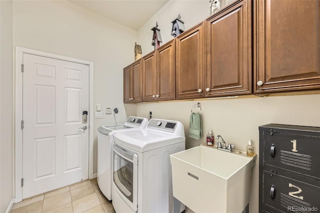 16626 Las Brisas Dr, Broomfield, CO 80023 - laundry room with washer and clothes dryer, cabinet space, and light tile patterned floors