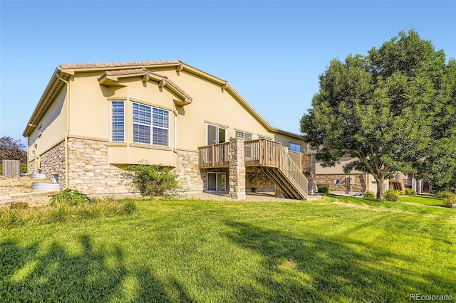 16626 Las Brisas Dr, Broomfield, CO 80023 - back of house featuring stone siding, stairway, a wooden deck, stucco siding, and a lawn