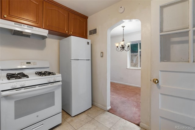 kitchen featuring a chandelier, white appliances, under cabinet range hood, brown cabinetry, and arched walkways