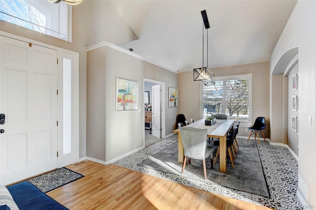 dining space featuring hardwood / wood-style floors and vaulted ceiling