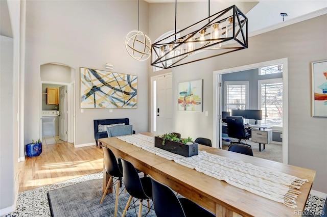 dining area with hardwood / wood-style floors and an inviting chandelier