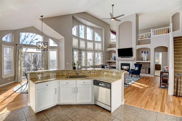 kitchen featuring white cabinets, dishwasher, pendant lighting, and light tile patterned floors