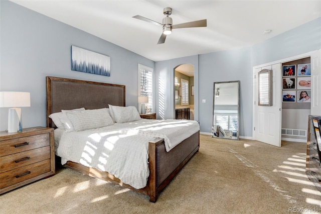 carpeted bedroom featuring multiple windows, a closet, and ceiling fan