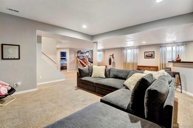 living room with light carpet and plenty of natural light