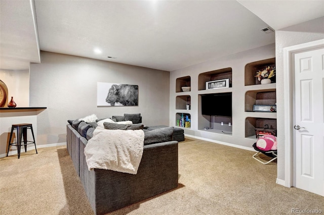 living room featuring carpet flooring and built in shelves