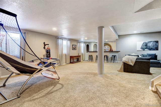 interior space featuring carpet flooring and a textured ceiling