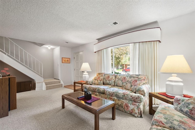 carpeted living room with a textured ceiling