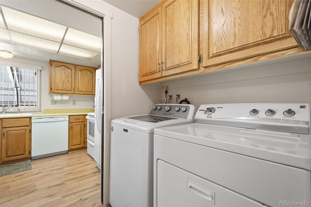 laundry room featuring light hardwood / wood-style floors and washer and dryer