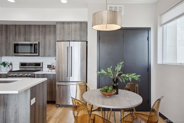 kitchen with stainless steel appliances, plenty of natural light, and modern cabinets