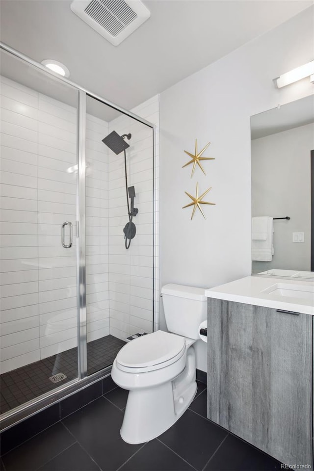 bathroom featuring a stall shower, visible vents, toilet, tile patterned floors, and vanity