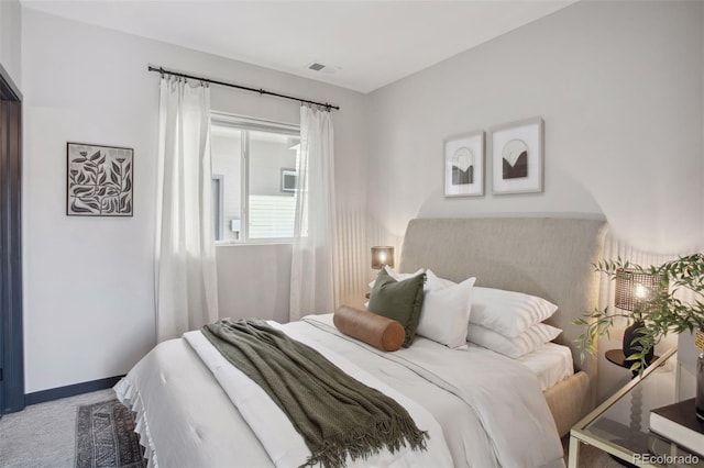 bedroom featuring baseboards, visible vents, and carpet flooring