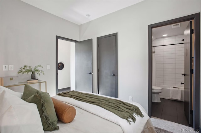 bedroom featuring visible vents and connected bathroom