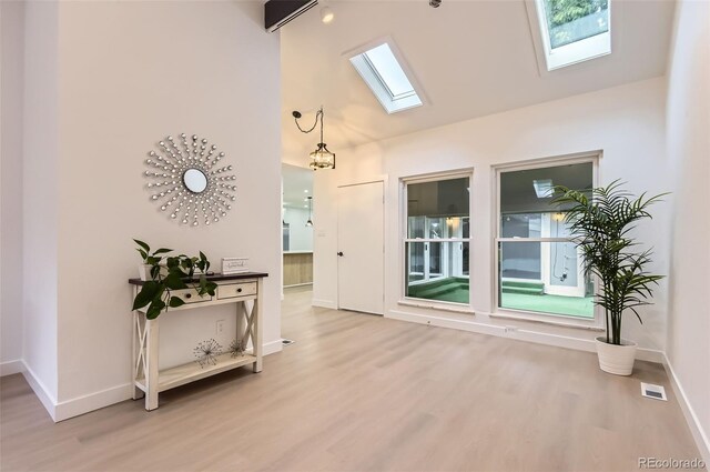 10295 E Evans Ave Unit 114, Aurora, CO 80247 - empty room with a skylight, wood finished floors, and high vaulted ceiling