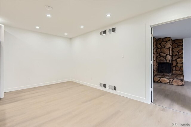 10295 E Evans Ave Unit 114, Aurora, CO 80247 - unfurnished room featuring light wood finished floors, recessed lighting, a fireplace, and a smoke detector