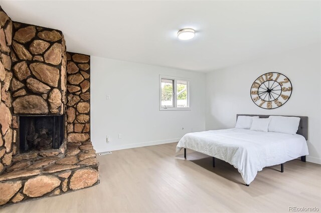 10295 E Evans Ave Unit 114, Aurora, CO 80247 - bedroom with wood finished floors and a fireplace