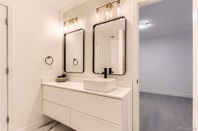 10295 E Evans Ave Unit 114, Aurora, CO 80247 - bathroom featuring vanity and wood finished floors
