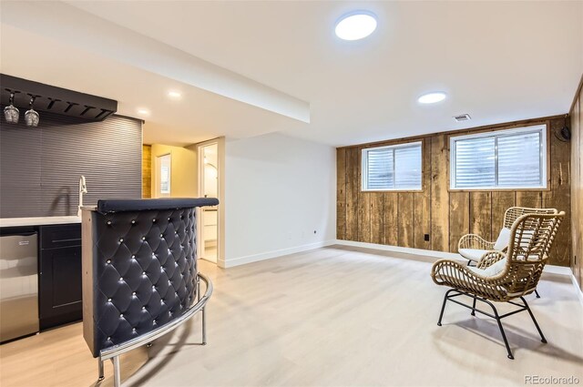 10295 E Evans Ave Unit 114, Aurora, CO 80247 - living area with bar area, light wood finished floors, wooden walls, and recessed lighting