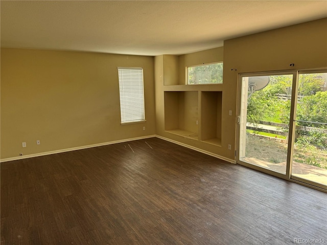 20304 E 47th Pl, Denver, CO 80249 - spare room featuring dark wood-type flooring and baseboards