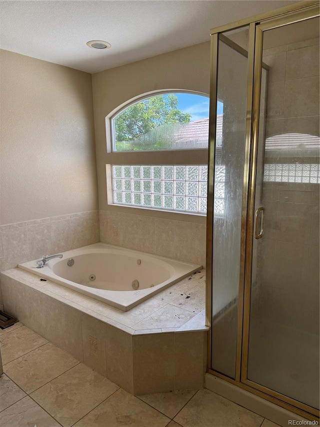 20304 E 47th Pl, Denver, CO 80249 - bathroom with a stall shower, a whirlpool tub, and tile patterned floors
