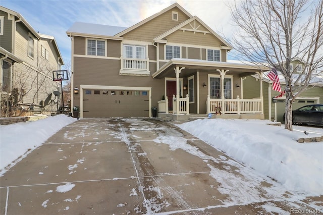 view of front of property featuring covered porch and a garage