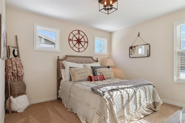 carpeted bedroom with multiple windows