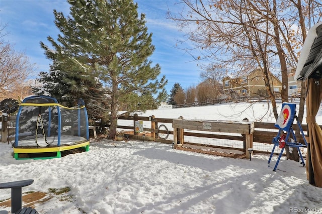 snowy yard with a trampoline