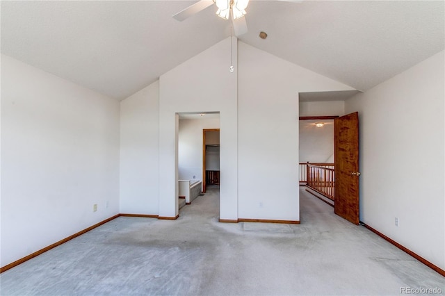 unfurnished bedroom featuring vaulted ceiling, carpet flooring, baseboards, and a ceiling fan