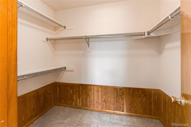 walk in closet featuring light colored carpet