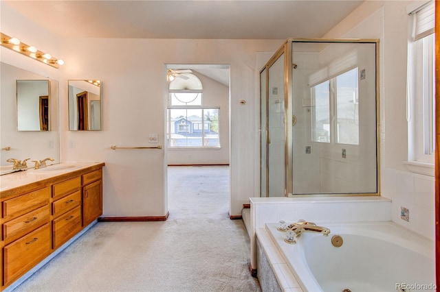 bathroom with a bath, a shower with door, double vanity, and ceiling fan